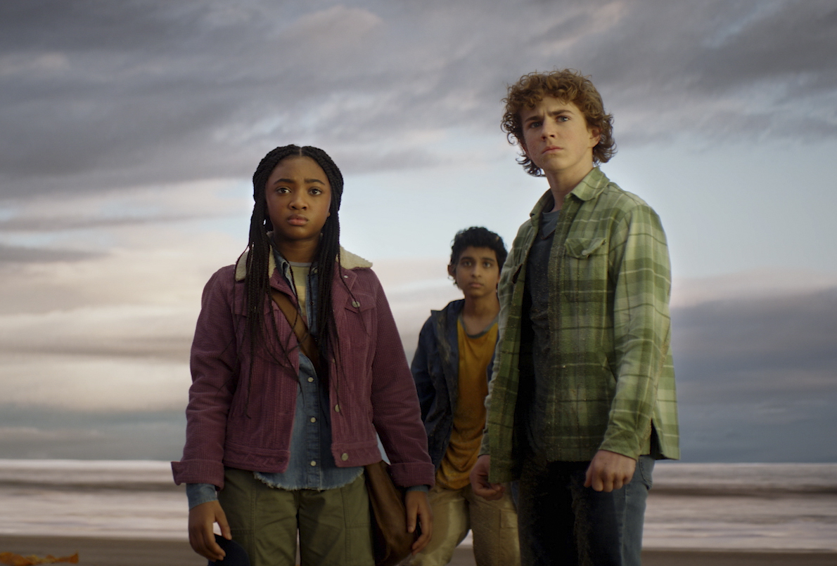 Annabeth, Grover, and Percy in the Percy Jackson TV adaptation standing on a gloomy beach