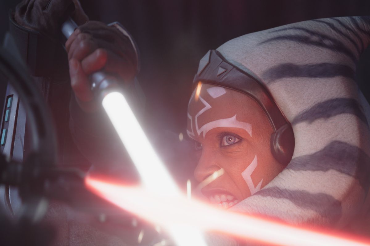 Ahsoka (Rosario Dawson) using her lightsaber to block someone with a red lightsaber
